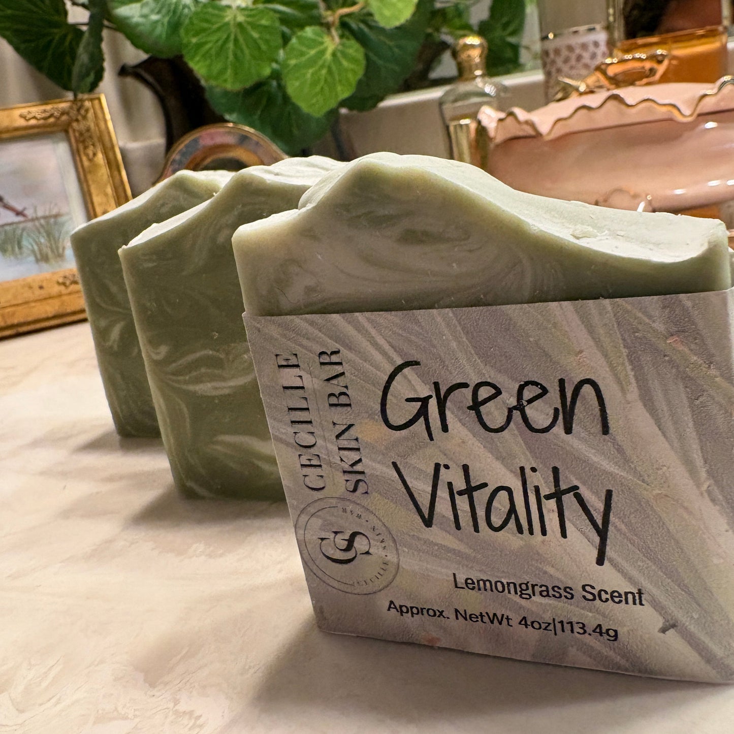 green vitality  handmade soap bar in a paper sleeve, other two behind do not have paper sleeve